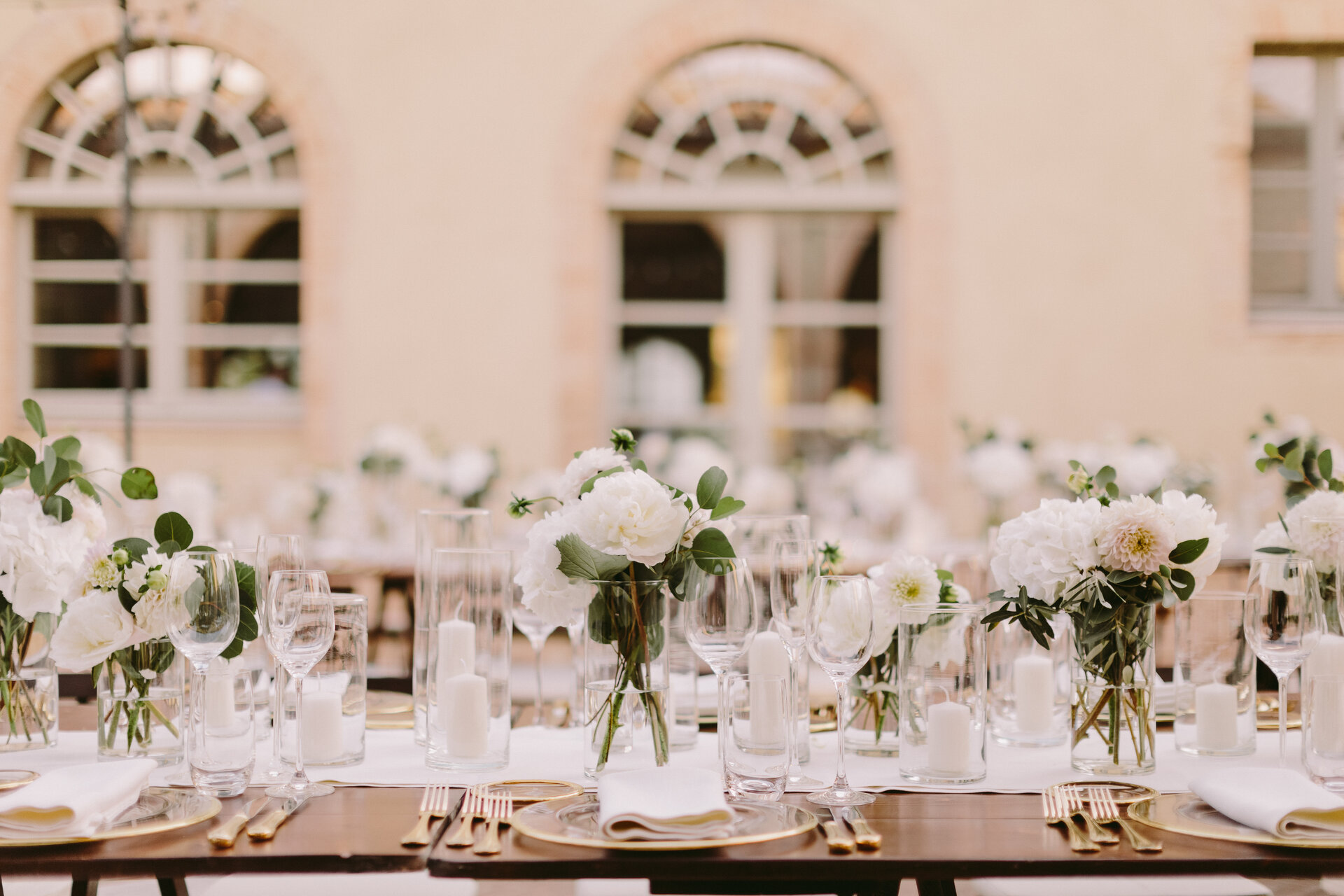 Event table place settings and floral arrangements